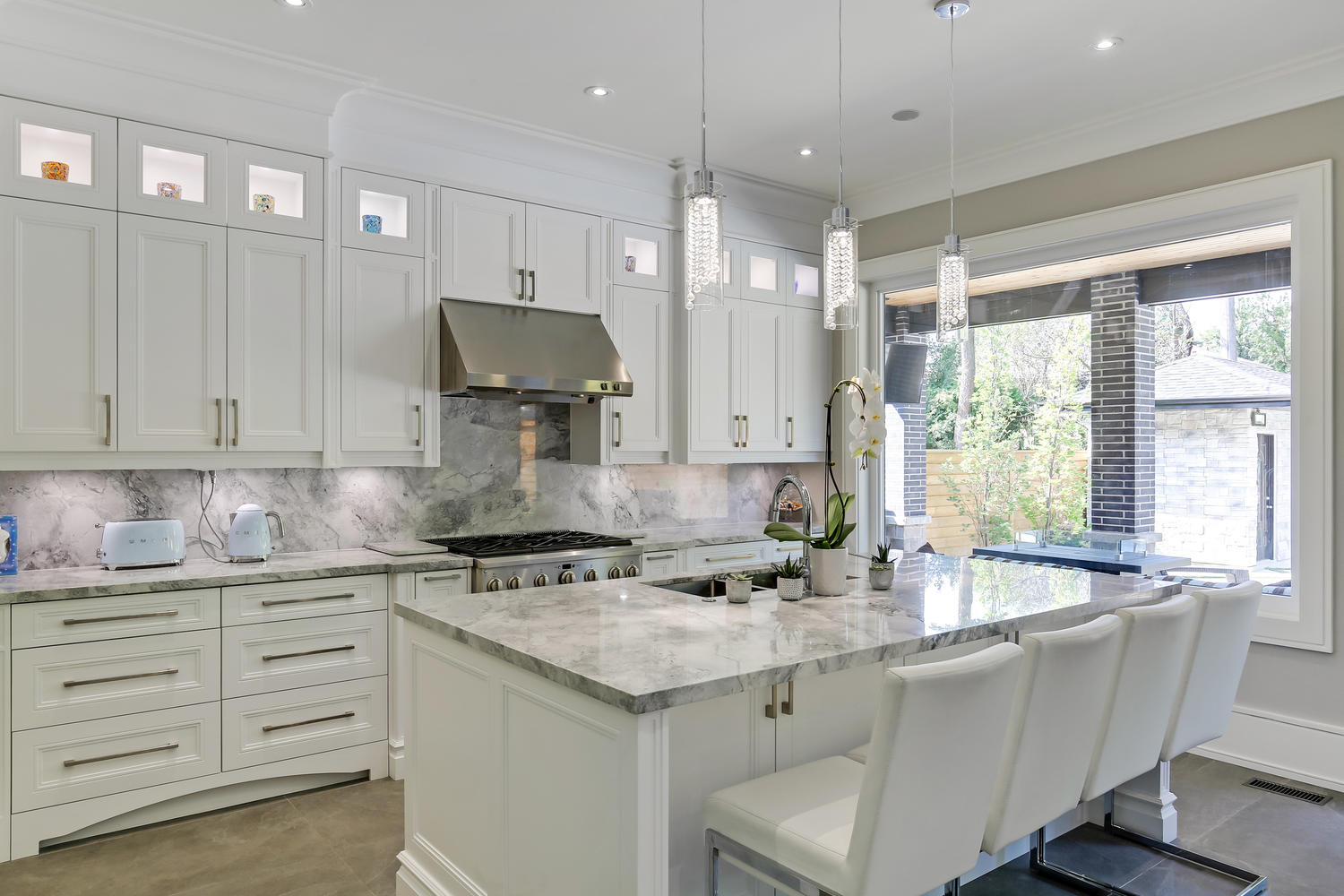 a kitchen area with white cabinets