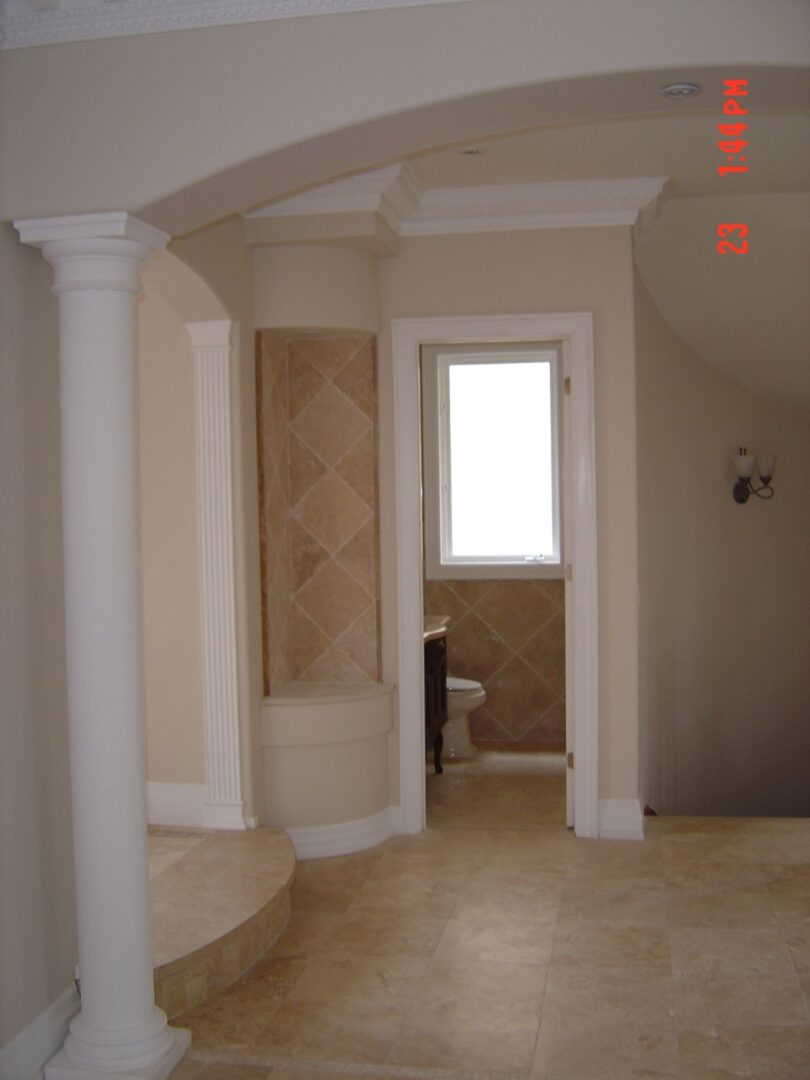 The Entrance of a Bathroom With a White Door Frame