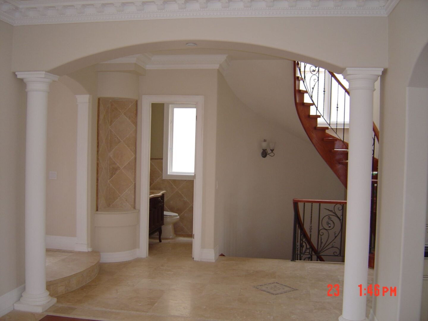 A White Wall With Cream Detailing With Pillars