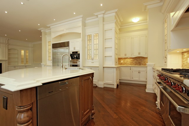 A Large Kitchen With a Block Island and a Marble Counter
