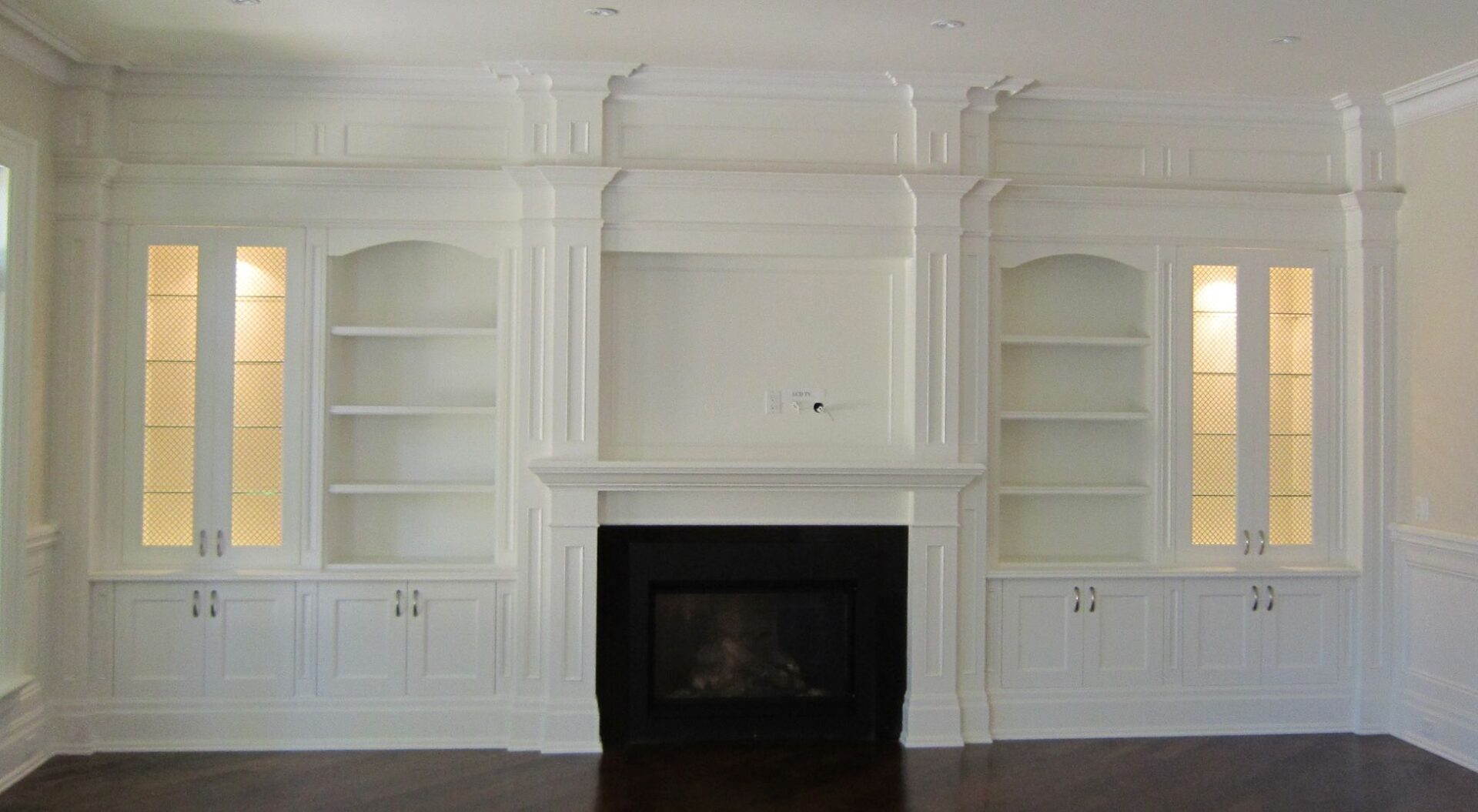 A While Color Cupboards With a Fireplace in the Middle