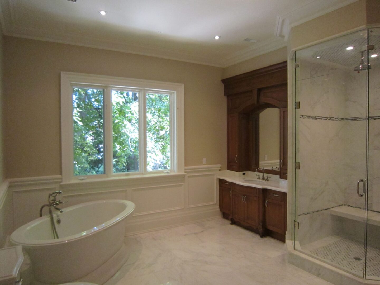 A Bathroom With a Glass Shower With a White Tub