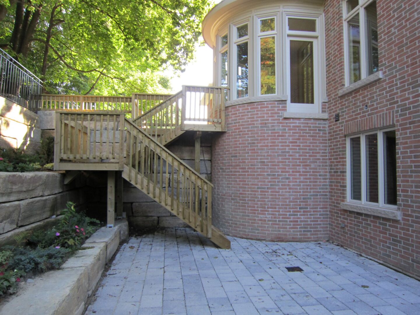 A Brick Wall Building With Wooden Stairs