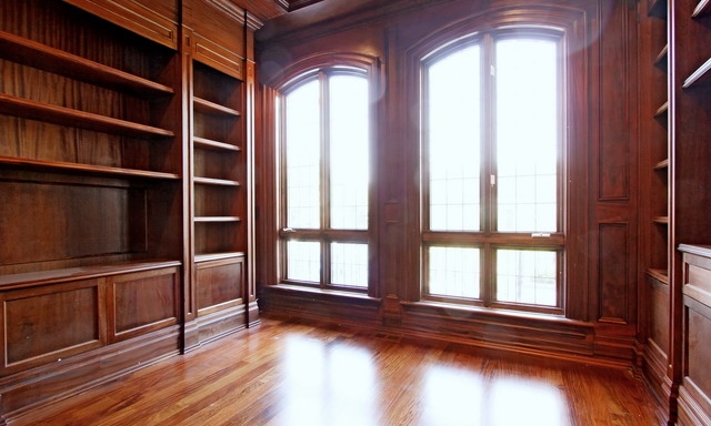 A Full Wooden Shelves in an Empty Room