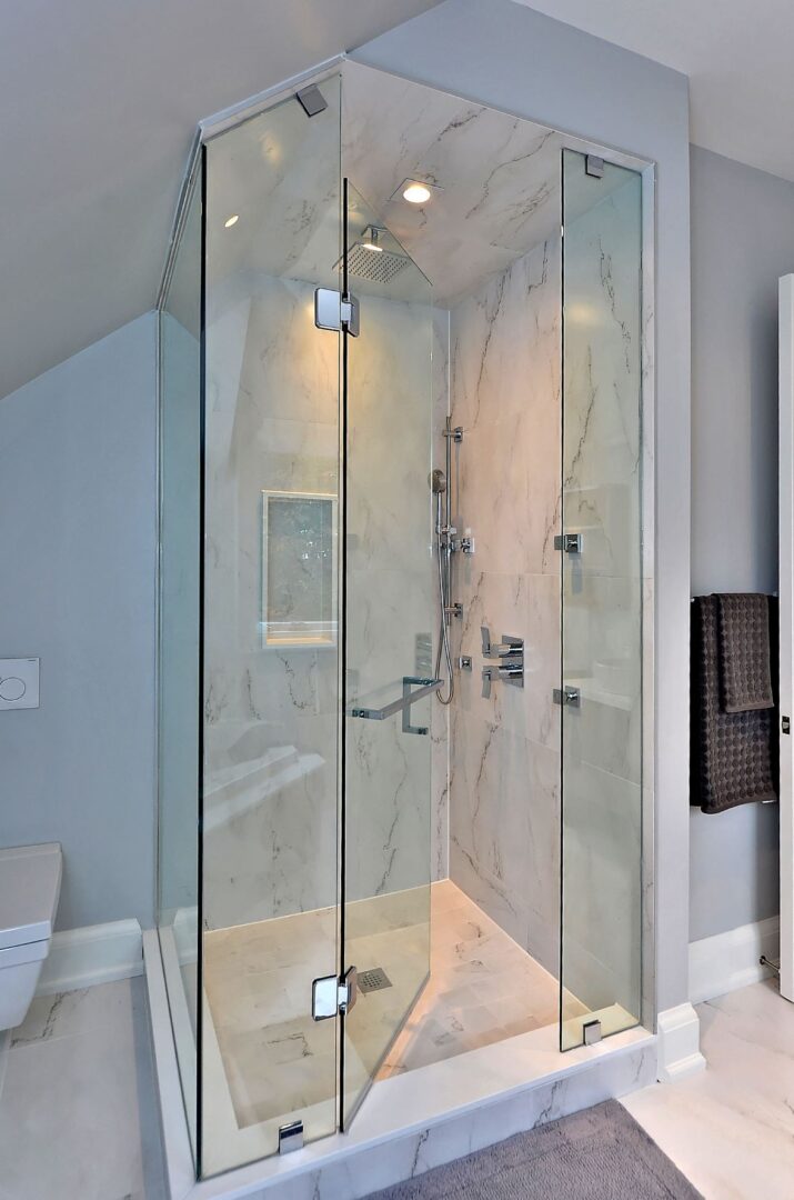 A Glass Cabinet Shower ON a Marble Platform