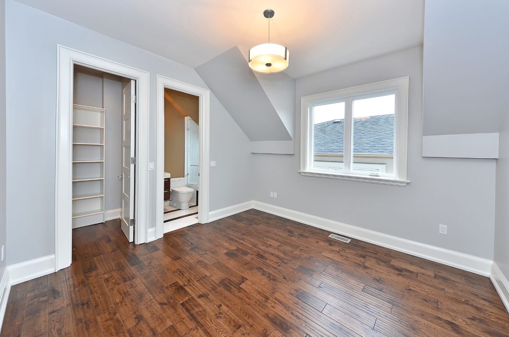 An Empty Room With Wood Panel Flooring