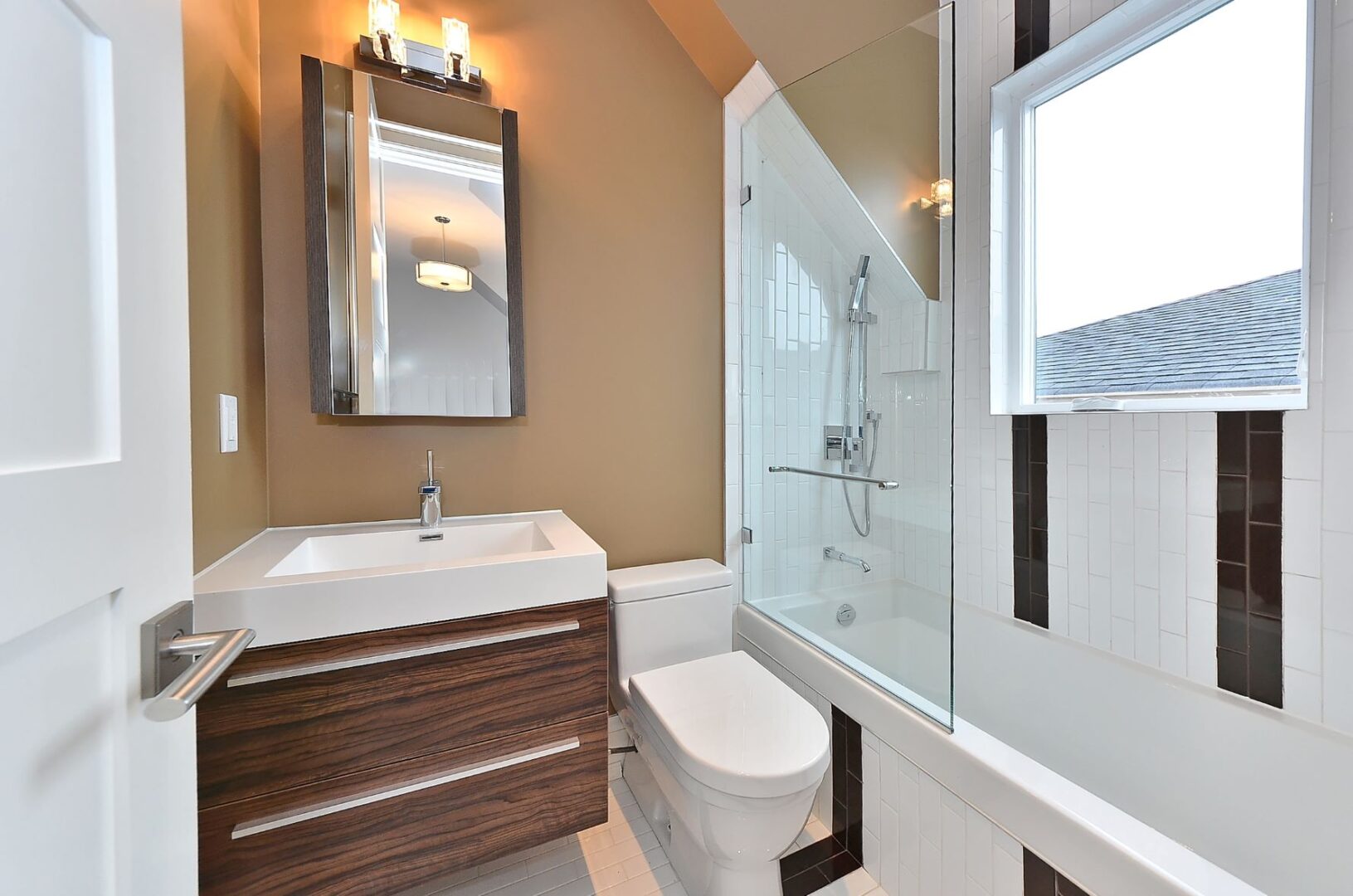 A Bathroom With White Fittings and Wood Cabinets