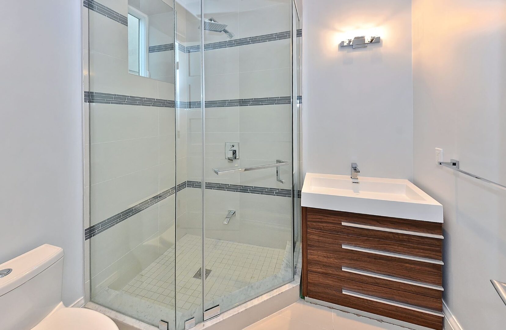 A Corner Shower Cabinet With a Sink Beside