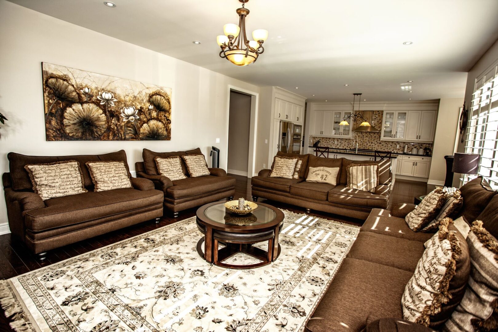 A Living Room With Brown Couches and a Carpet