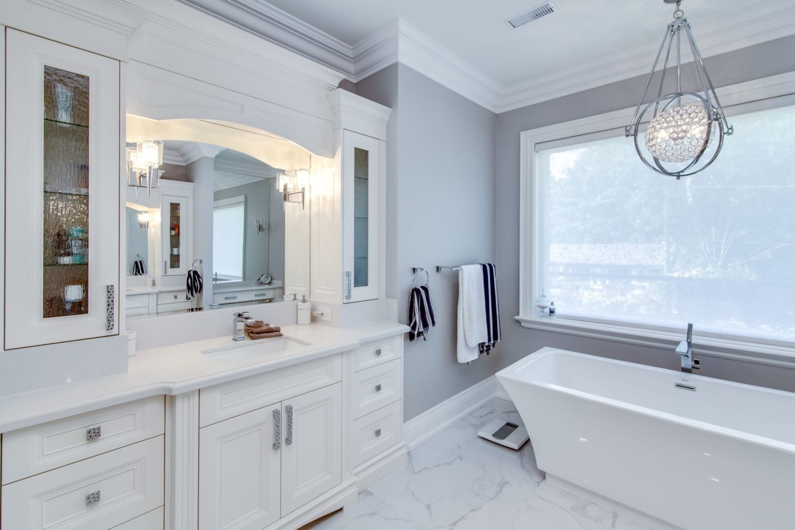 a stylish white themed bathroom with a tub