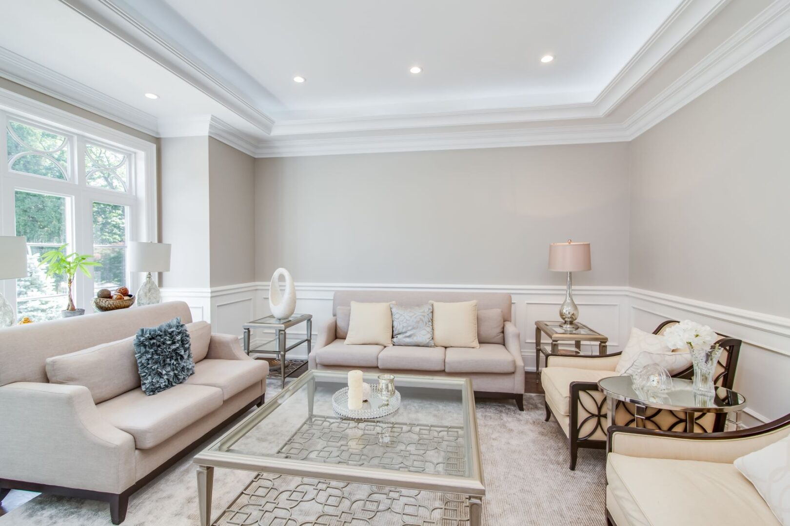 a living room with cream color sofas