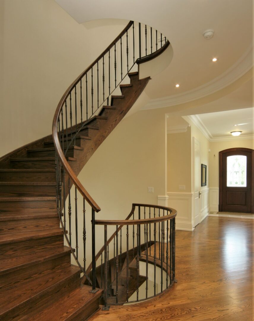A Wooden Staircase With Iron Railing