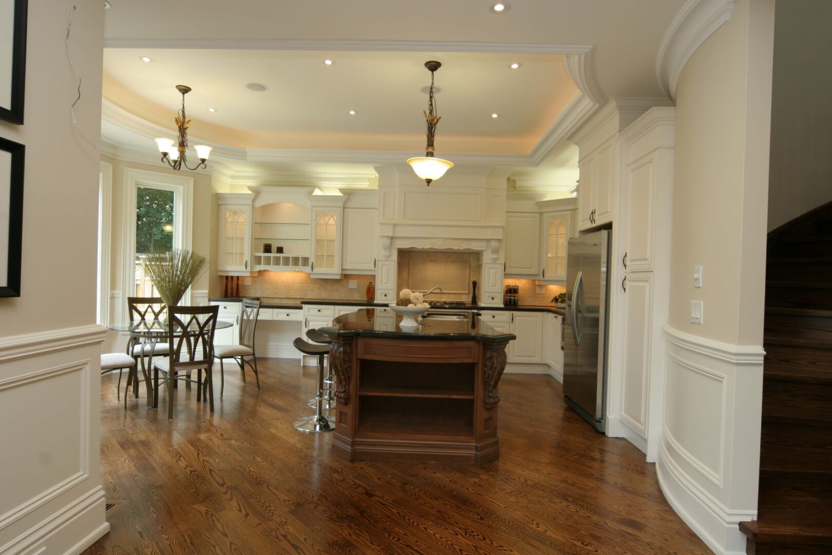 A Kitchen With an Island and White Archways
