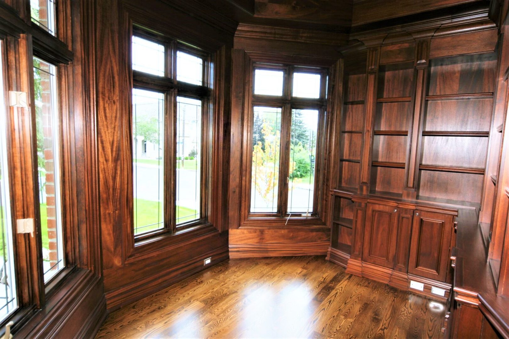 A Wooden Shelf Corner With Large Glass Doors