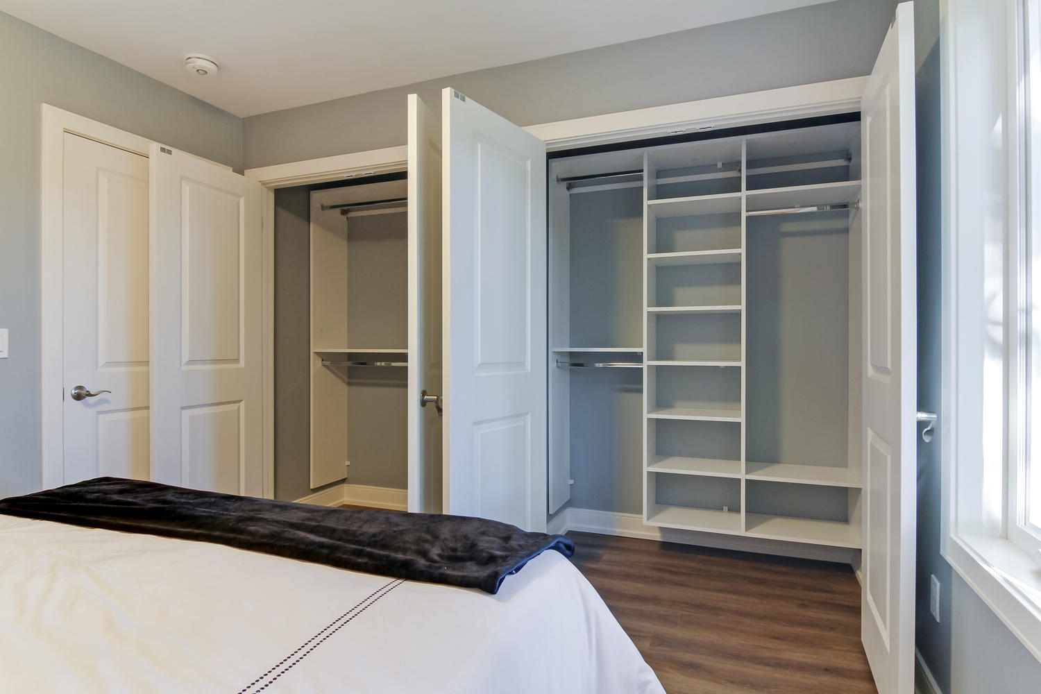 A Wide Opened Closet With White Shelves