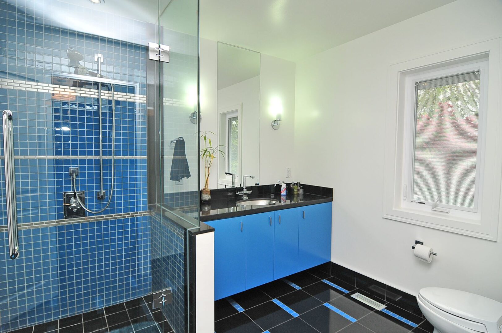 A Blue Counter With Blue Tile Shower Wall