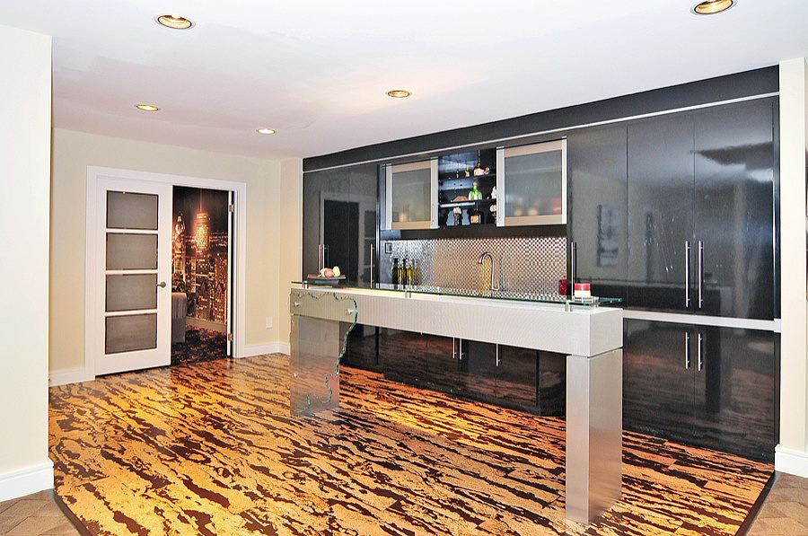 A Kitchen With an Island in Glass Surface